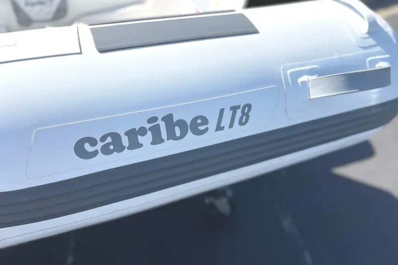 Slide: The Image of 2025 Caribe L8 inflatable boat, white exterior, close-up view. - 4