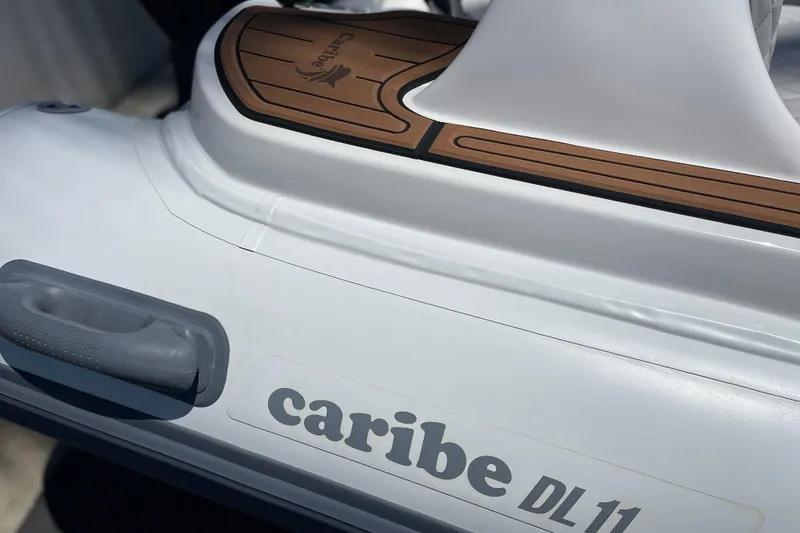 Slide: The Image of 2025 Caribe DL11 inflatable boat with sleek design and durable materials. - 11