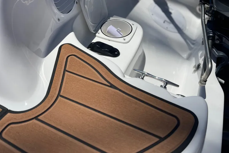 Slide: The Image of Interior of 2025 Caribe DL11 boat with wood-textured flooring and sleek design elements. - 13