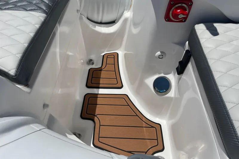 Slide: The Image of Interior of 2025 Caribe DL11 boat with quilted seats and wooden floor mat. - 14
