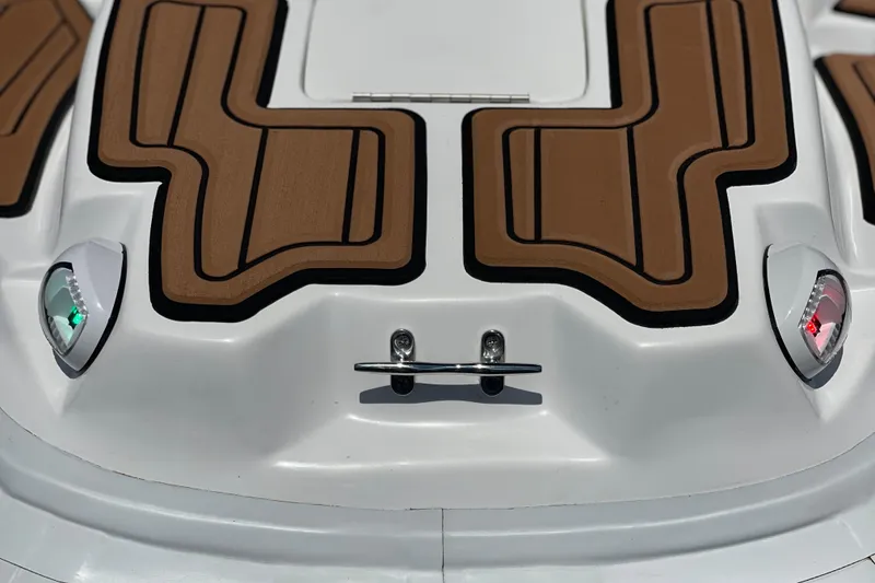 Slide: The Image of Bow of Caribe DL11 boat, 2025 model, featuring brown deck pads and navigation lights. - 15