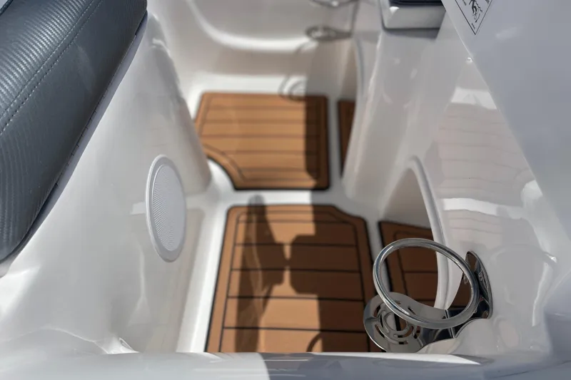 Slide: The Image of Interior of 2025 Caribe DL11 boat with wood flooring and cup holder. - 17