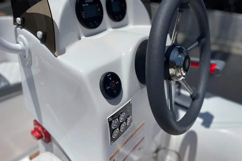 Slide: The Image of Steering console of 2025 Caribe DL11 boat with modern controls and sleek design. - 29