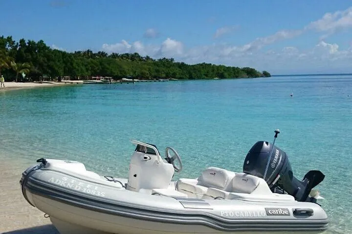 Slide: The Image of Inflatable Caribe DL11 boat on a tropical beach, 2025 model, clear blue water. - 40