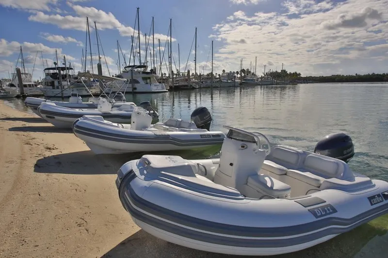 Slide: The Image of Inflatable Caribe DL11 boats docked on a sunny marina, 2025 model. - 50