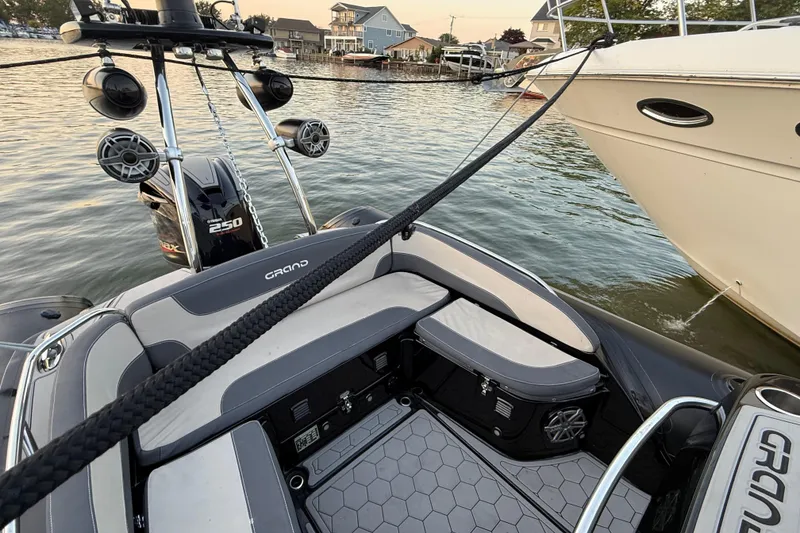 Slide: The Image of 2018 Grand Goldenline G650 HGLF Custom boat on calm water at sunset. - 6