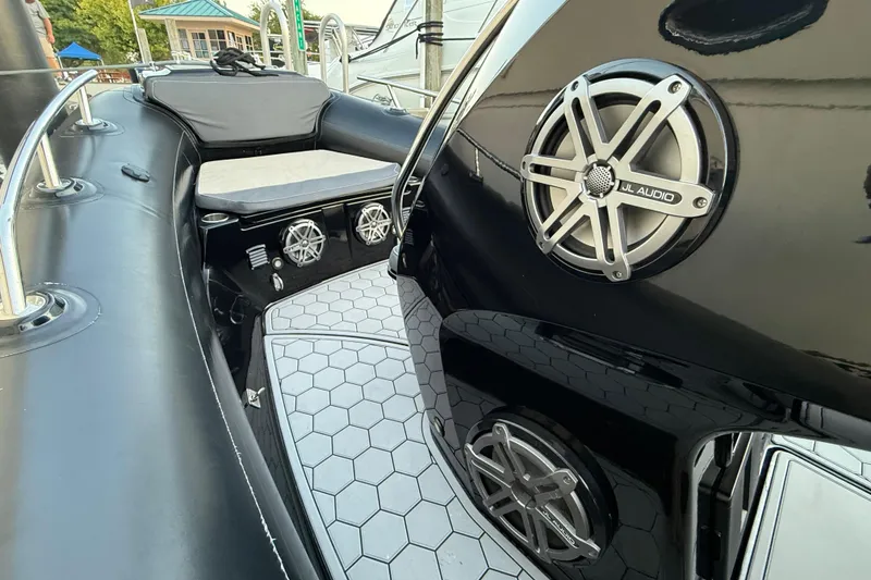 Slide: The Image of 2018 Grand Goldenline G650 HGLF Custom boat interior with sleek black seating and modern design. - 9