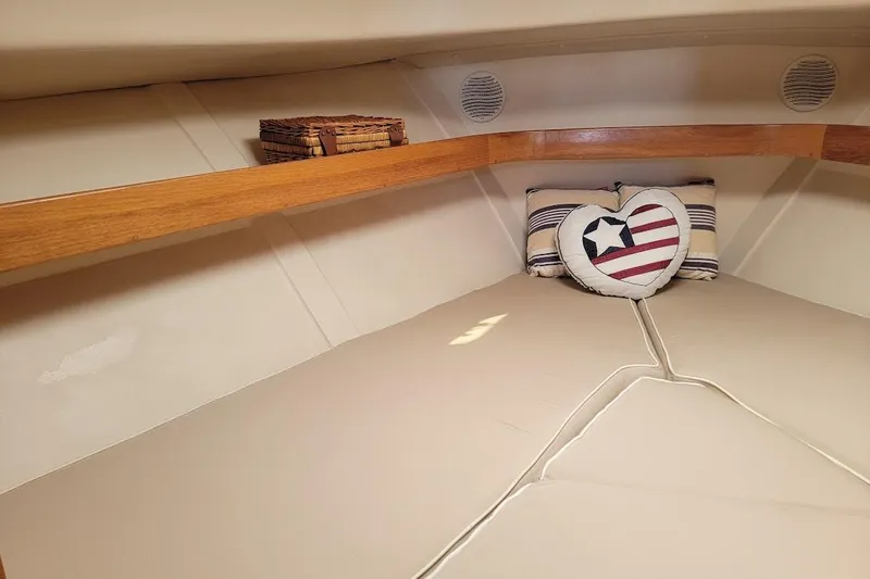 Slide: The Image of Cozy cabin interior of 2000 Mainship 34 PILOT with nautical-themed decor. - 10