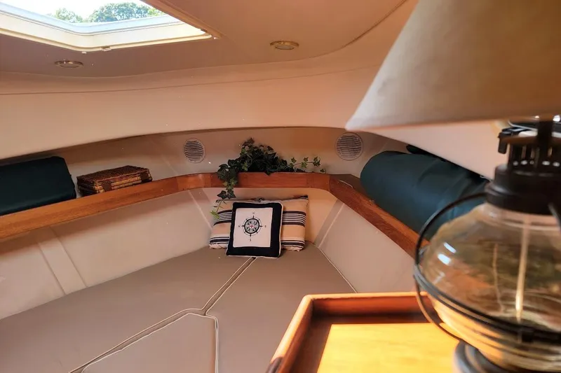 Slide: The Image of Cozy cabin interior of 2000 Mainship 34 PILOT with nautical decor and soft lighting. - 13