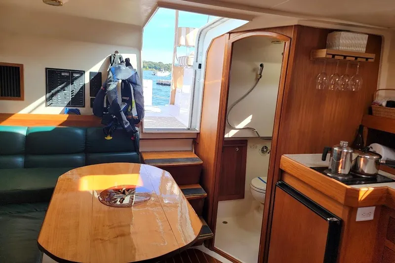 Slide: The Image of Interior of 2000 Mainship 34 PILOT yacht with cozy seating and kitchenette. - 17