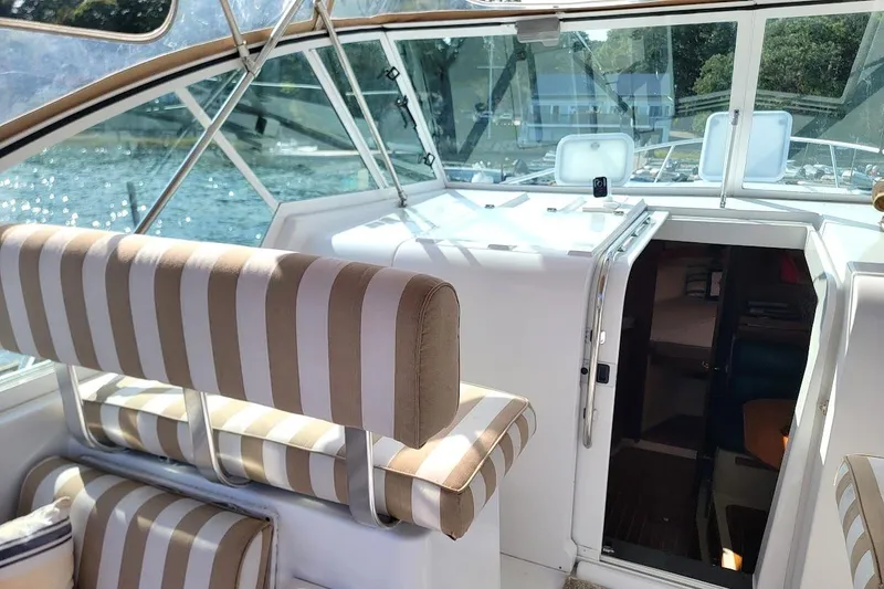 Slide: The Image of Interior view of a 2000 Mainship 34 PILOT boat with striped seating. - 19