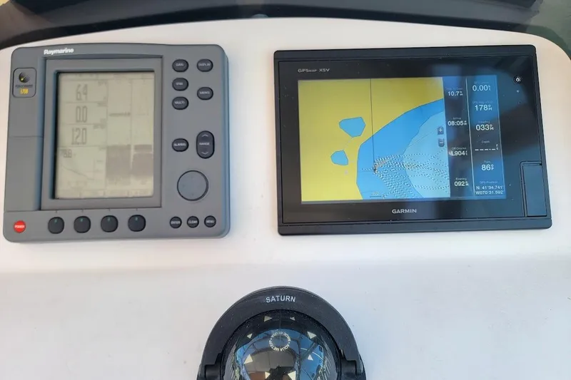 Slide: The Image of Boat navigation system with Raymarine and Garmin displays on a 2000 Mainship 34 Pilot. - 21