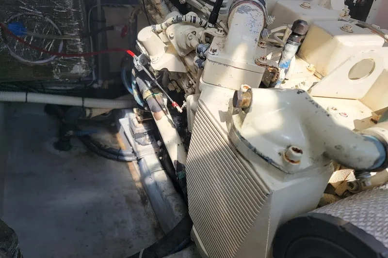 Slide: The Image of Engine compartment of a 2000 Mainship 34 PILOT boat, showing mechanical components. - 24