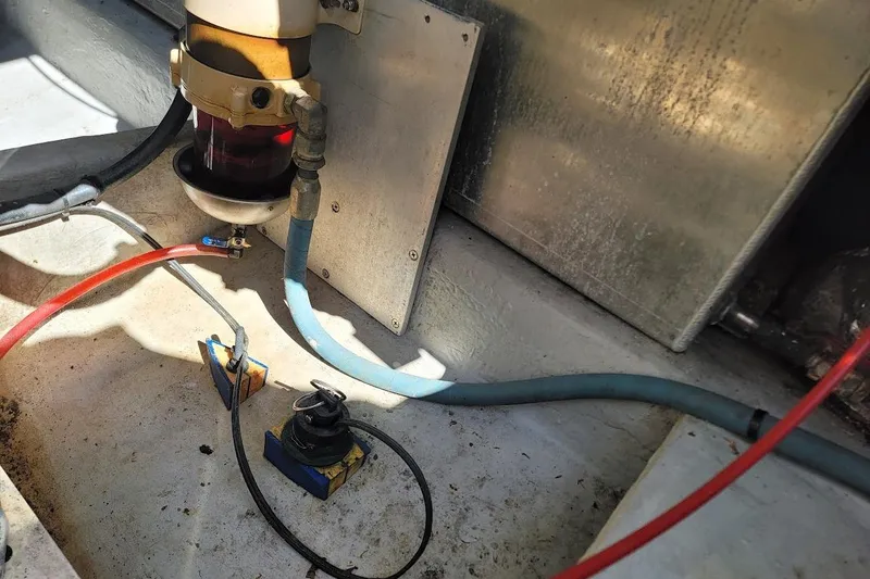 Slide: The Image of Engine compartment of 2000 Mainship 34 PILOT with visible hoses and components. - 25