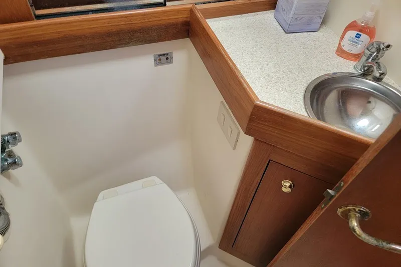 Slide: The Image of Bathroom interior of 2000 Mainship 34 PILOT boat with sink and toilet. - 29