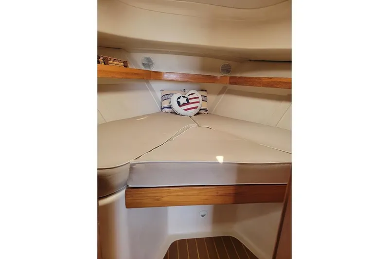 Slide: The Image of Cozy cabin interior of 2000 Mainship 34 PILOT with nautical-themed pillows. - 30
