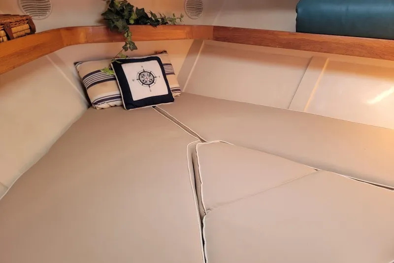 Slide: The Image of Cozy cabin interior of 2000 Mainship 34 PILOT with nautical-themed pillows. - 31