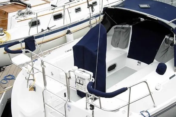 Slide: The Image of 2005 Catalina 320 sailboat with covered cockpit, docked at marina. - 2