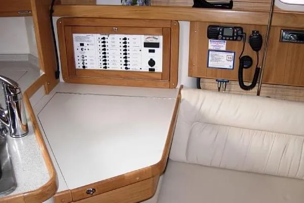 Slide: The Image of Interior of a 2005 Catalina 320 sailboat with control panel and seating area. - 8