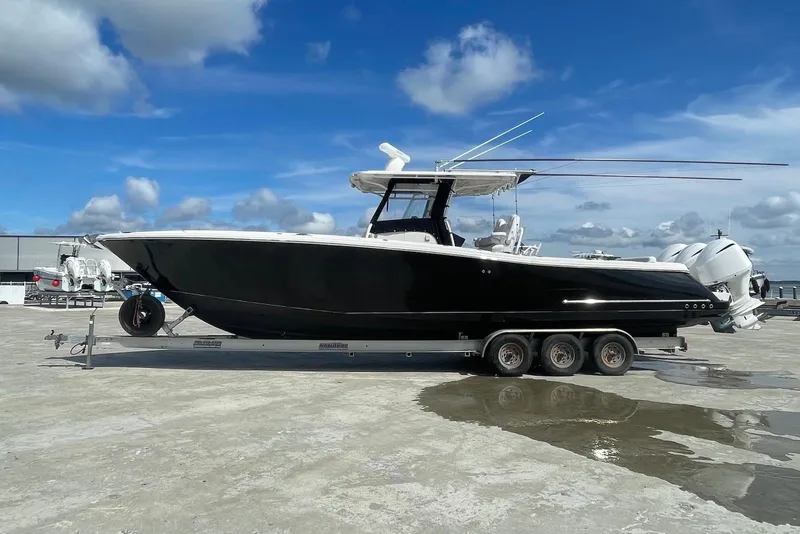 The Image of 2008 Edgewater 370CC boat on trailer under blue sky. - 0