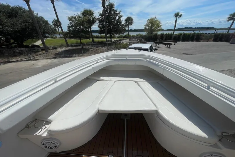 Slide: The Image of Edgewater 370CC 2008 boat with spacious seating and scenic waterfront view. - 10