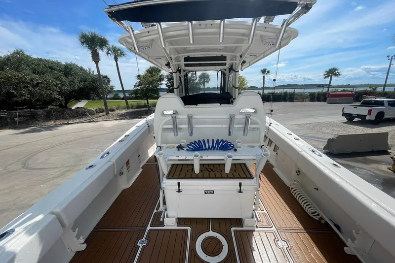 Slide: The Image of 2008 Edgewater 370CC boat interior with teak flooring and fishing equipment. - 11