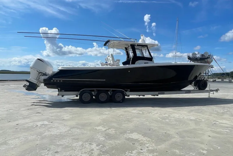 Slide: The Image of 2008 Edgewater 370CC boat on trailer under blue sky. - 2