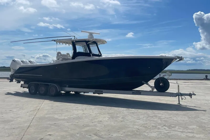 Slide: The Image of 2008 Edgewater 370CC boat on trailer under blue sky, ready for launch. - 3