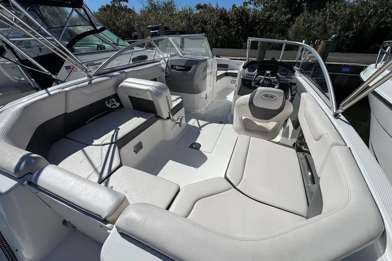 Slide: The Image of 2018 Chaparral 230 Suncoast boat interior with spacious seating and modern dashboard. - 11