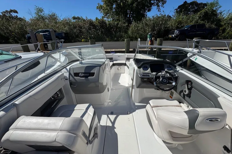 Slide: The Image of 2018 Chaparral 230 Suncoast boat interior with steering wheel and seating. - 12