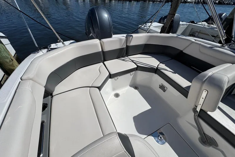 Slide: The Image of 2018 Chaparral 230 Suncoast boat interior with spacious seating and sleek design. - 13