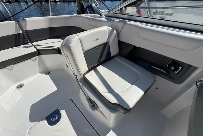 Slide: The Image of 2018 Chaparral 230 Suncoast boat interior with gray seating and control panel. - 14