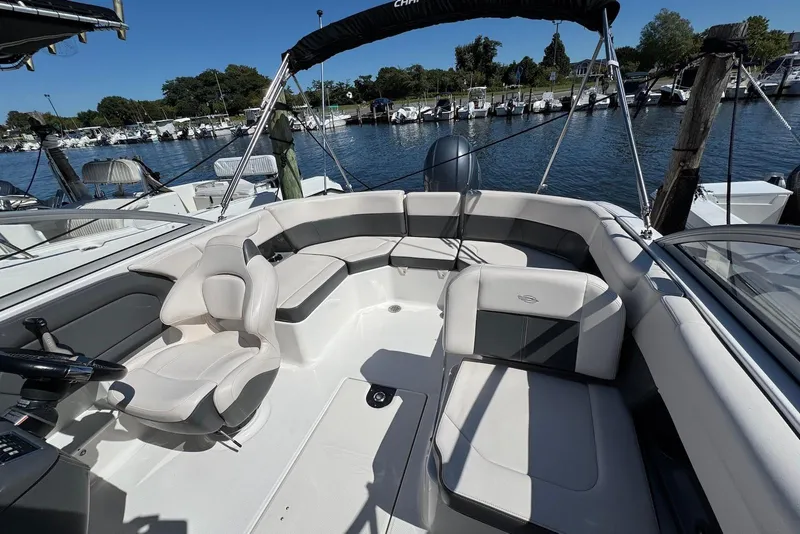 Slide: The Image of 2018 Chaparral 230 Suncoast boat interior with seating, docked at marina. - 16