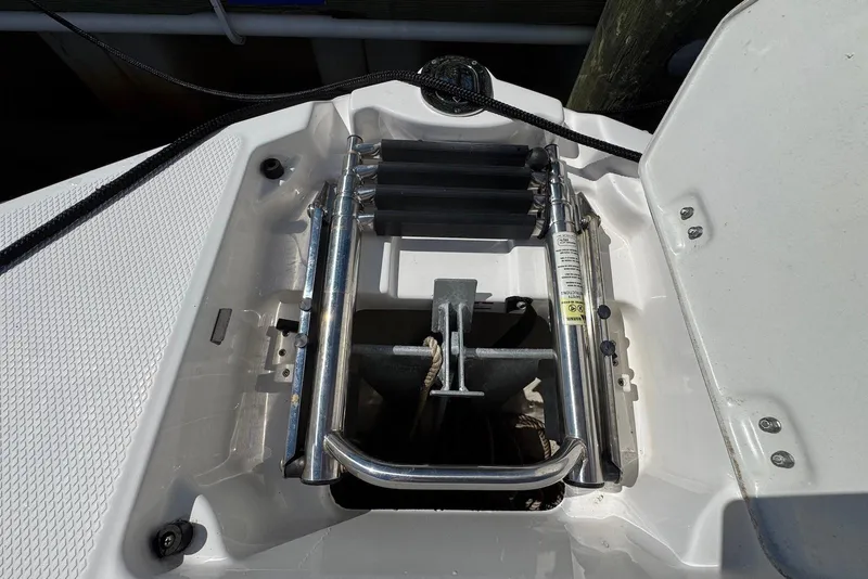 Slide: The Image of 2018 Chaparral 230 Suncoast boat ladder and anchor storage compartment. - 17