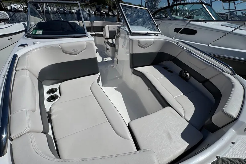 Slide: The Image of 2018 Chaparral 230 Suncoast boat interior with spacious seating and cup holders. - 18