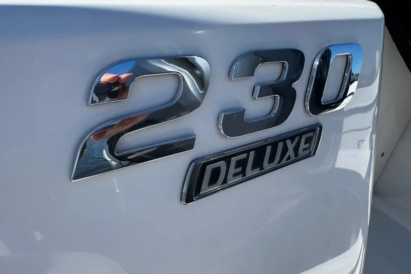 Slide: The Image of Close-up of 2018 Chaparral 230 Suncoast Deluxe chrome emblem on white surface. - 21