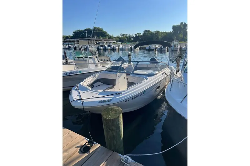 Slide: The Image of 2018 Chaparral 230 Suncoast boat docked at marina, covered and ready for use. - 4