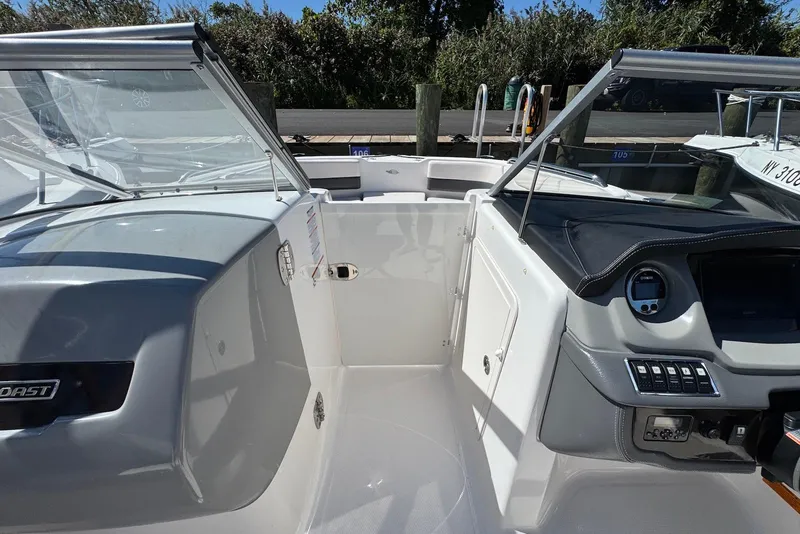 Slide: The Image of 2018 Chaparral 230 Suncoast boat interior with dashboard and seating area. - 7