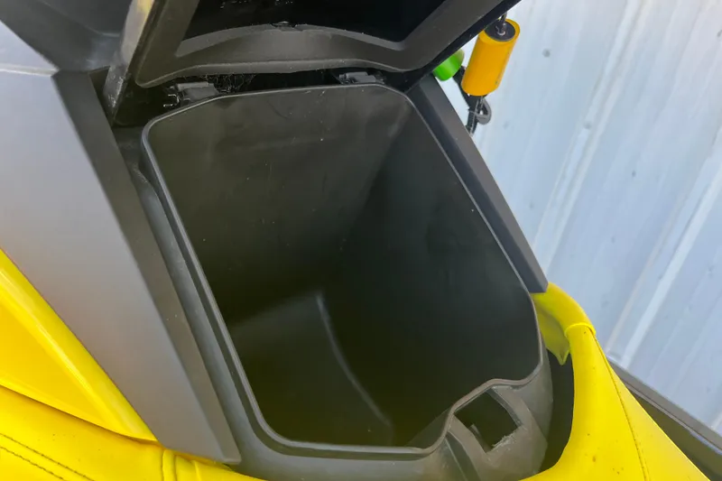 Slide: The Image of Close-up of a 2016 Sea-Doo GTR 215 with textured black surface and yellow seat. - 19