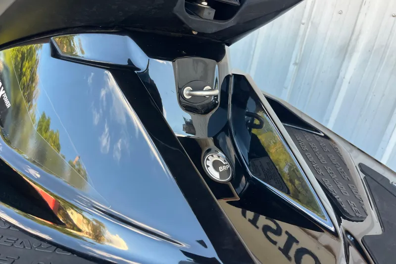 Slide: The Image of 2016 Sea-Doo GTR 215 jet ski, rear view, parked near a metal building. - 25