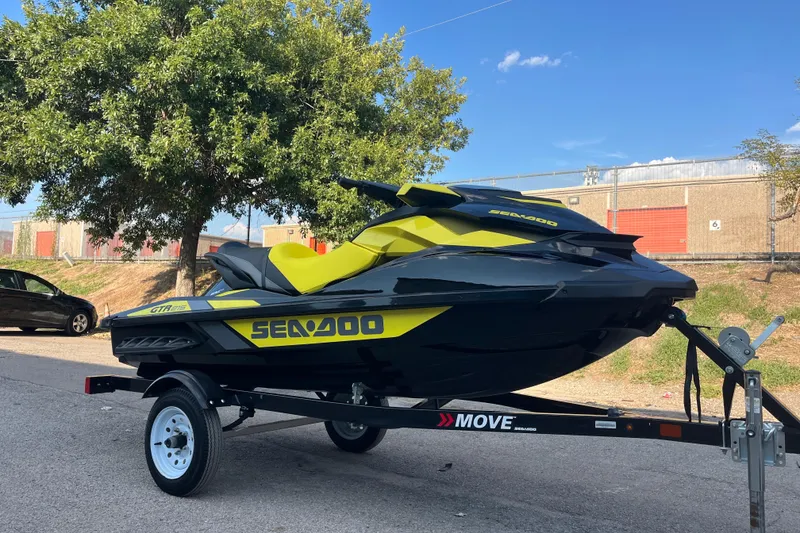 Slide: The Image of 2016 Sea-Doo GTR 215 jet ski on trailer, black and yellow design. - 3