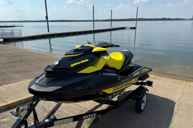 Slide: The Image of 2016 Sea-Doo GTR 215 jet ski on trailer by a lake dock. - 39