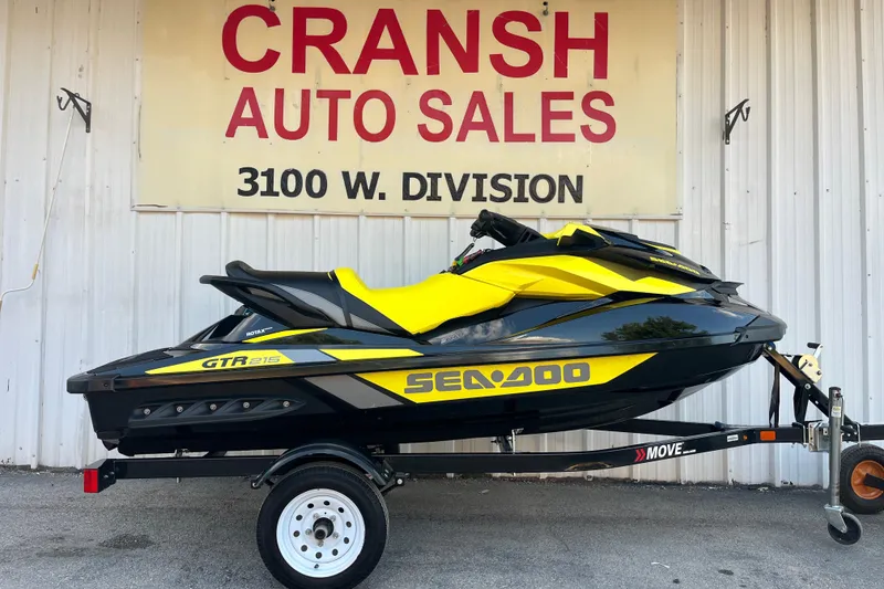 Slide: The Image of 2016 Sea-Doo GTR 215 jet ski on trailer, parked outdoors under a tree. - 4