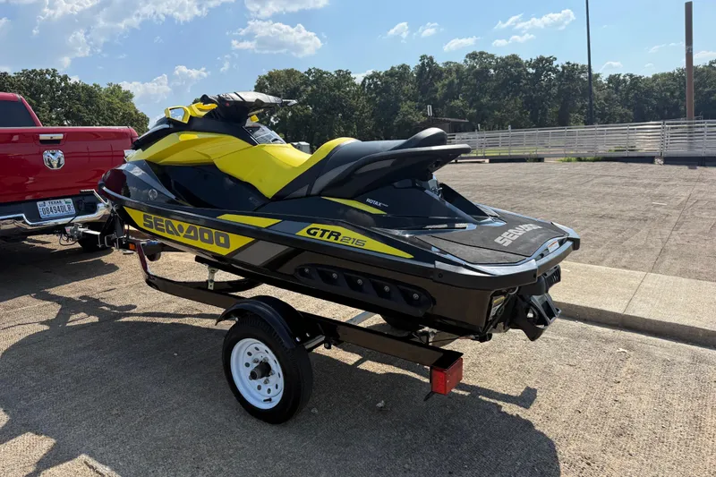 Slide: The Image of 2016 Sea-Doo GTR 215 jet ski on trailer, parked near a red truck. - 44