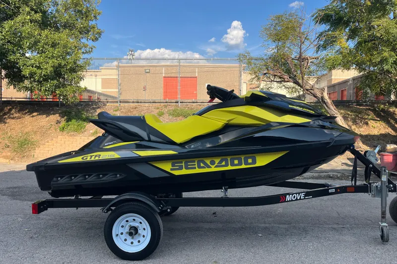 Slide: The Image of 2016 Sea-Doo GTR 215 jet ski on trailer, parked outdoors. - 5
