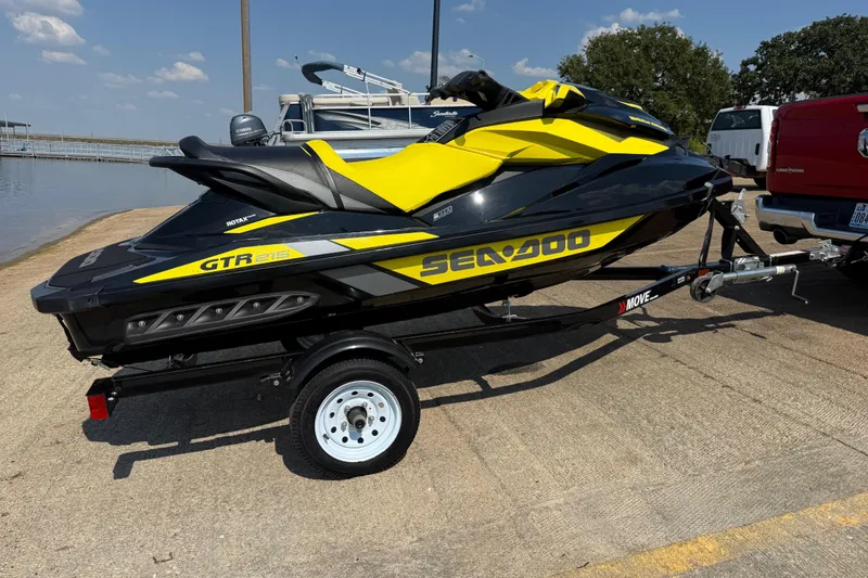 Slide: The Image of 2016 Sea-Doo GTR 215 jet ski on trailer by the water. - 50