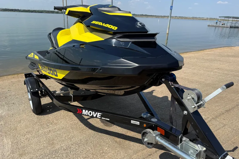 Slide: The Image of 2016 Sea-Doo GTR 215 jet ski on trailer by a lake. - 54