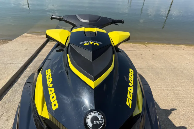 Slide: The Image of 2016 Sea-Doo GTR 215 jet ski on a concrete ramp by the water. - 56
