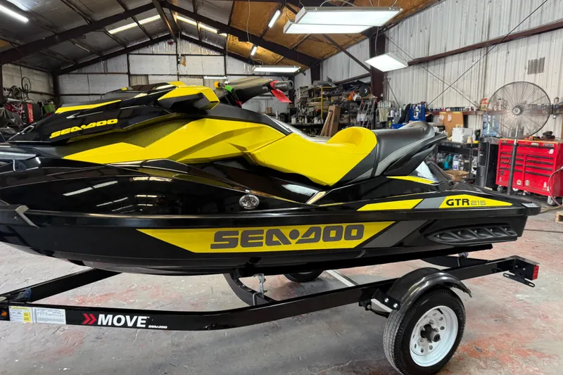Slide: The Image of 2016 Sea-Doo GTR 215 jet ski in a garage, yellow and black design. - 6