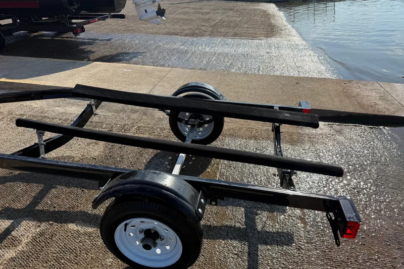 Slide: The Image of Empty boat trailer on a wet boat ramp near water, ready for Sea-Doo GTR 215. - 63
